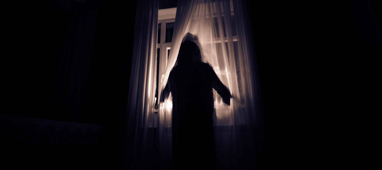 Silhouette of woman in window